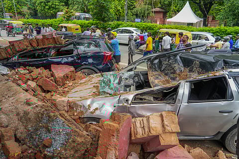 Cars crushed under debris after a wall of Happy School collapsed due to heavy rains on Wednesday, in Darya Ganj area of New Delhi